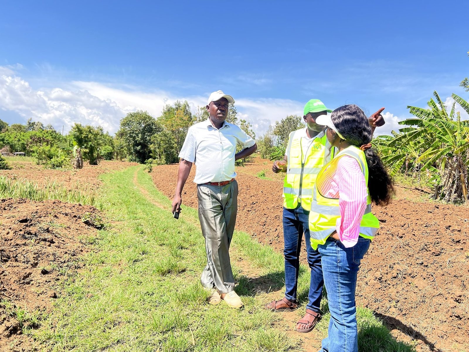 Worth Alliance field staff and a local farmer discussing prepared farmland