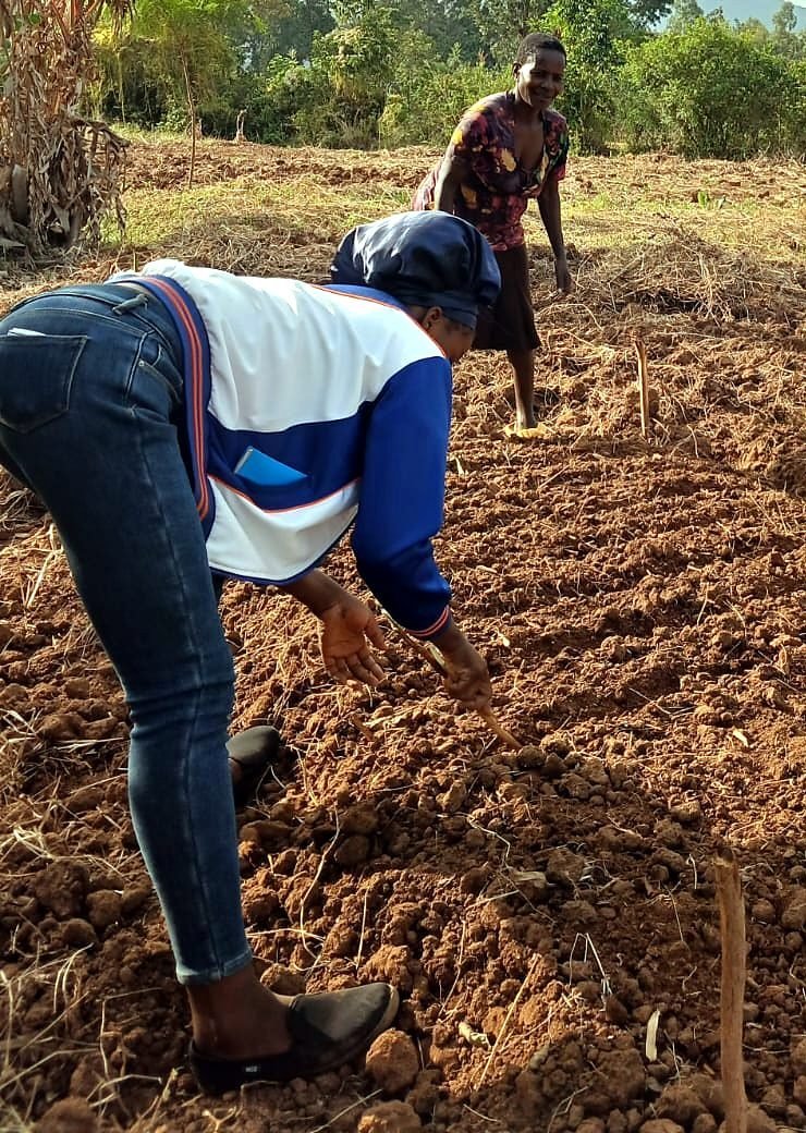 A farmer and a Worth Alliance field officer on her land